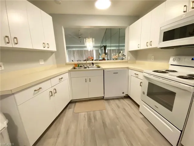 a kitchen with cabinets a sink and appliances