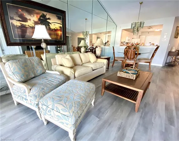 a living room with furniture flat screen tv and wooden floor