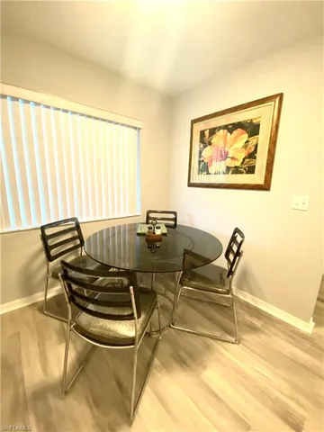 a dining room with chairs and a table with wooden floor