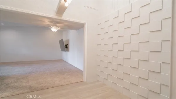 an empty room with windows and entrance