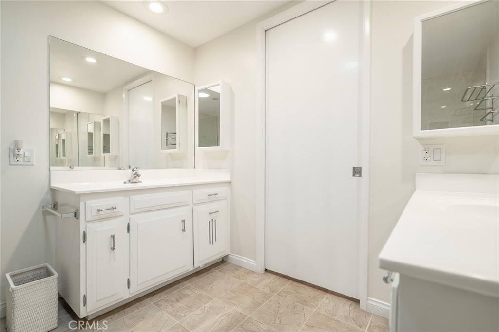 1880 St John Road Seal Beach, CA 90740 - Photo 19 of 30 a spacious bathroom with a double vanity sink and a mirror