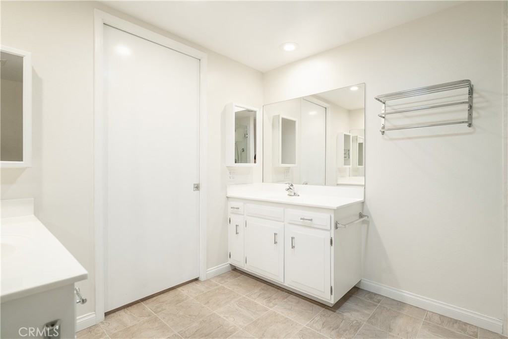 1880 St John Road Seal Beach, CA 90740 - Photo 20 of 30 a view of a bathroom with a sink and mirror