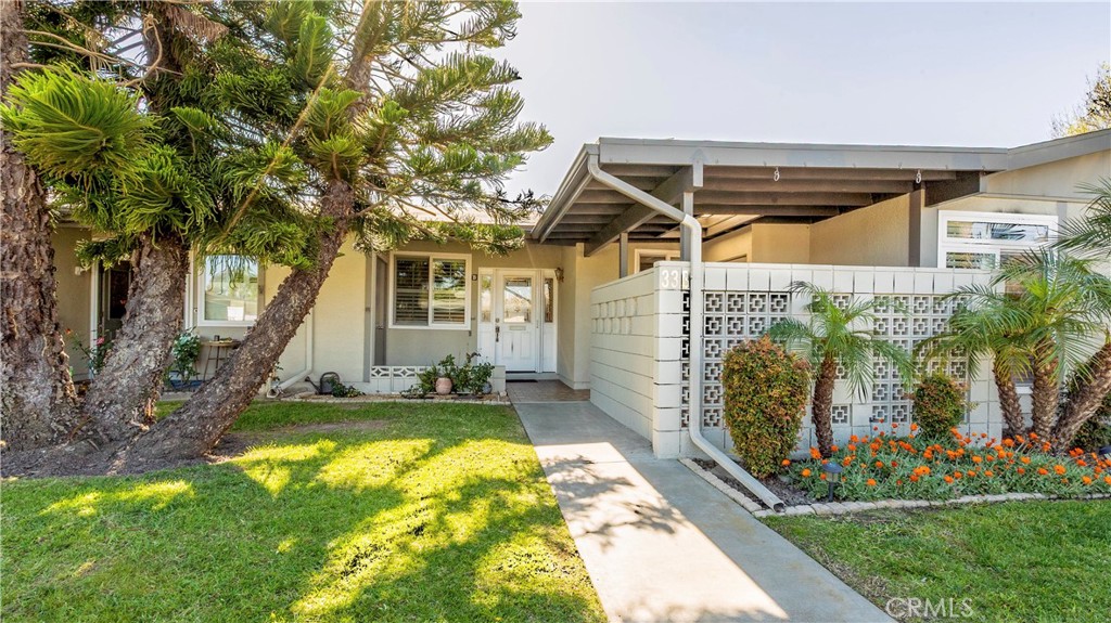 1880 St John Road Seal Beach, CA 90740 - Photo 2 of 30 a view of a house with swimming pool and a yard
