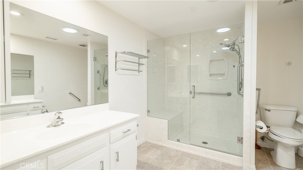 1880 St John Road Seal Beach, CA 90740 - Photo 23 of 30 a bathroom with a sink a toilet and shower