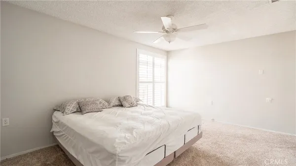 a bed sitting in a bedroom next to a window