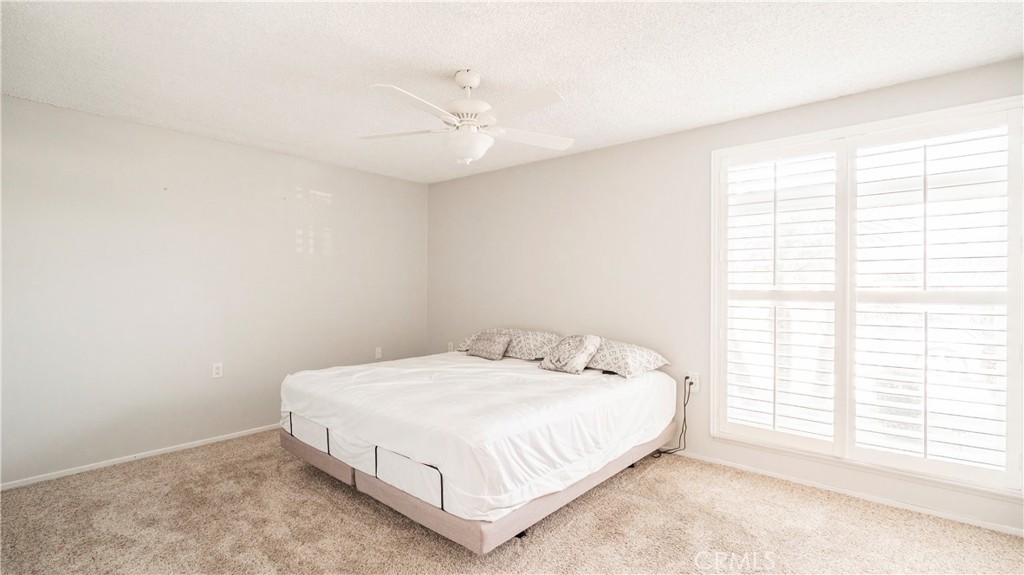 1880 St John Road Seal Beach, CA 90740 - Photo 27 of 30 a bed sitting in a bedroom next to a window