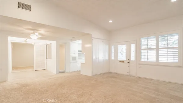an empty room with windows and closet