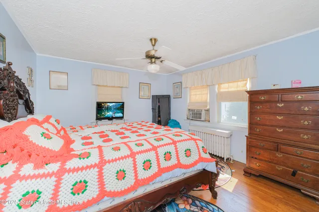 a bedroom with a bed and a dresser in it