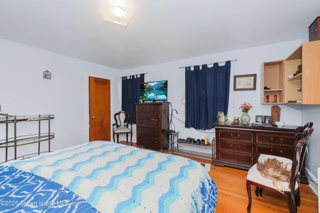 a bed room with a bed and a television