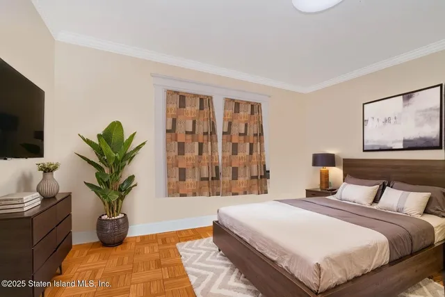 a bedroom with a bed and a potted plant