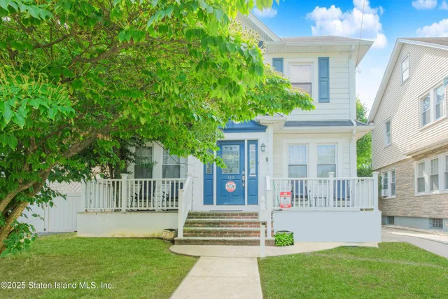 a front view of a house with a garden and plants