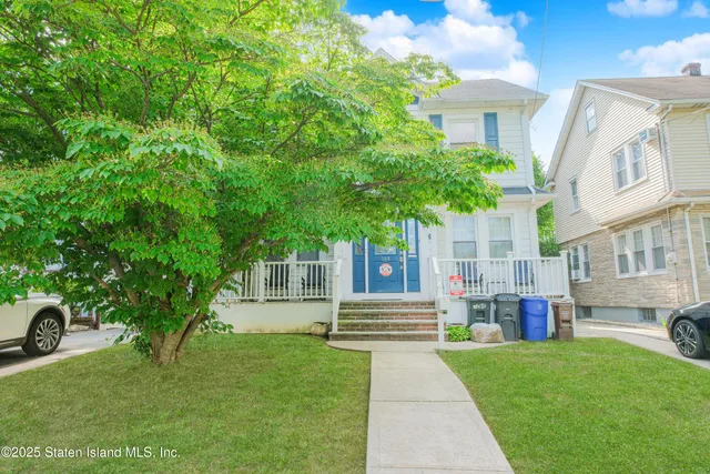a front view of a house with a garden