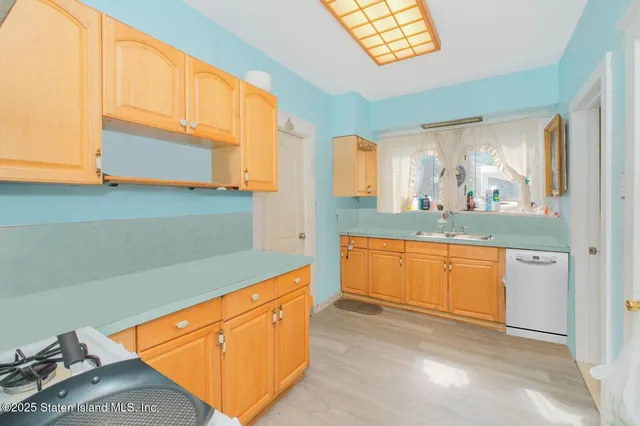 a kitchen with granite countertop a sink and a stove