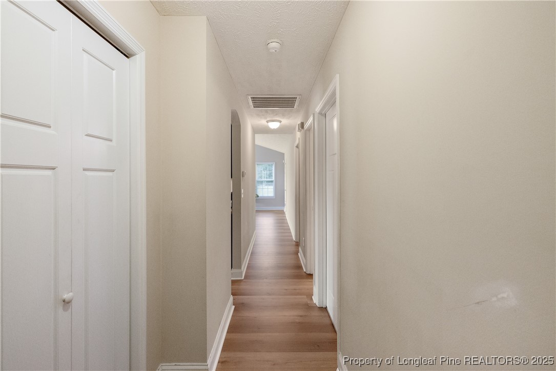 203 United Road Raeford, NC 28376 - Photo 14 of 36 a view of a hallway with wooden floor and staircase