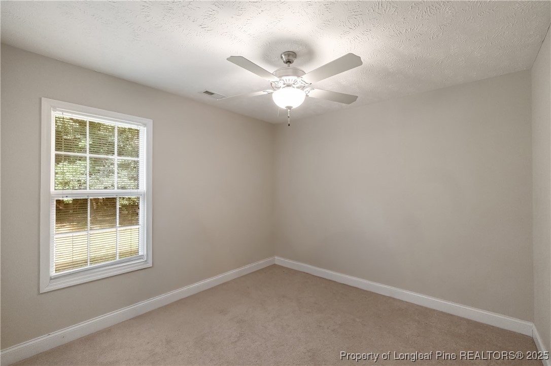 203 United Road Raeford, NC 28376 - Photo 19 of 36 an empty room with a window and ceiling fan