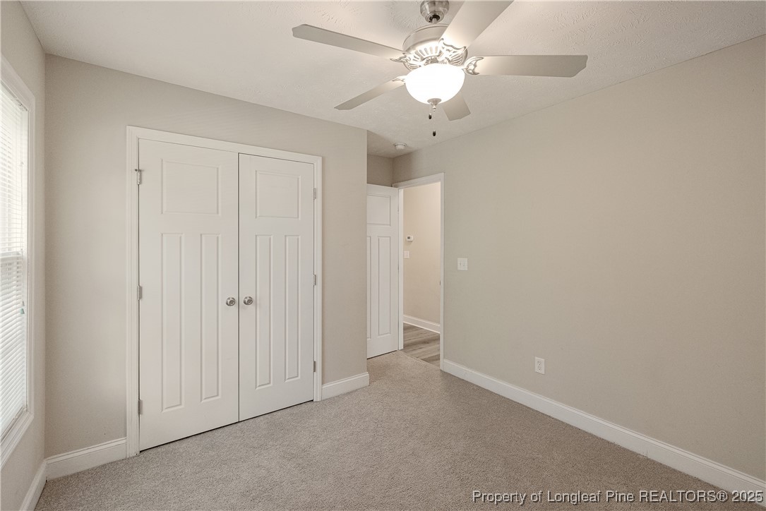 203 United Road Raeford, NC 28376 - Photo 22 of 36 an empty room with a ceiling fan and a window