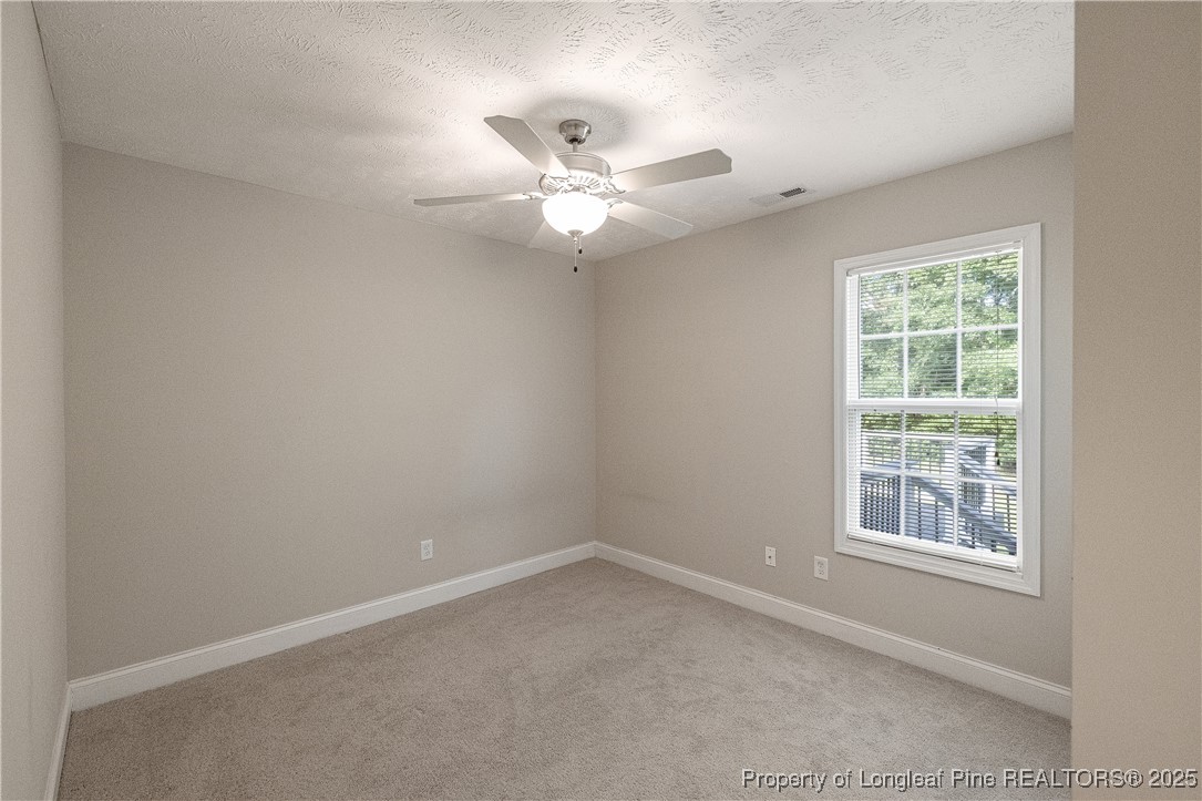 203 United Road Raeford, NC 28376 - Photo 23 of 36 an empty room with a window and ceiling fan