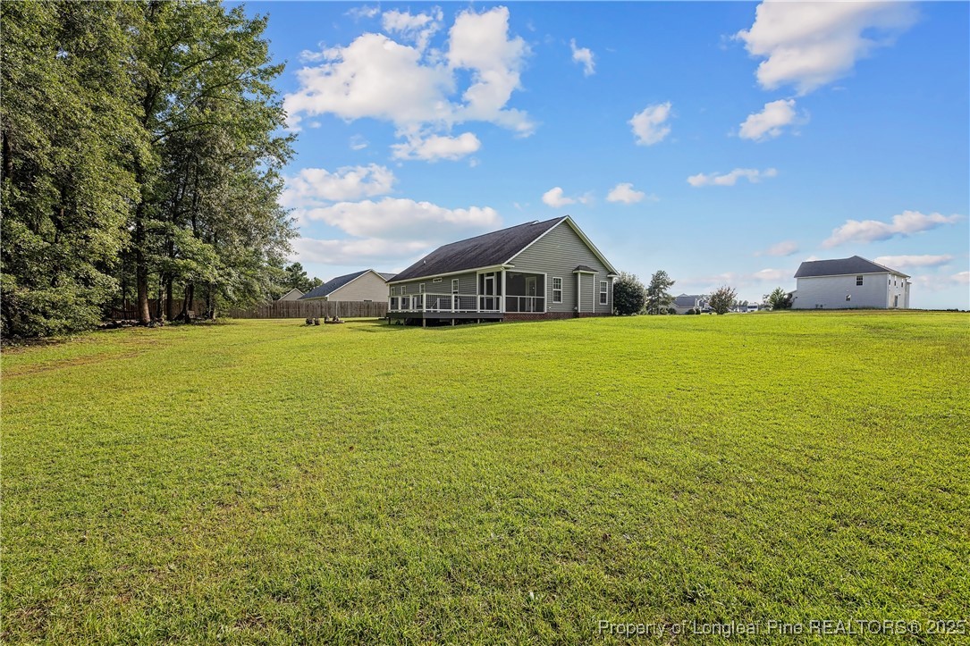 203 United Road Raeford, NC 28376 - Photo 32 of 36 a view of a large pool with lawn chairs under an umbrella