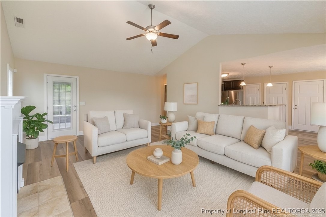 203 United Road Raeford, NC 28376 - Photo 4 of 36 a living room with furniture a ceiling fan a lamp and a window