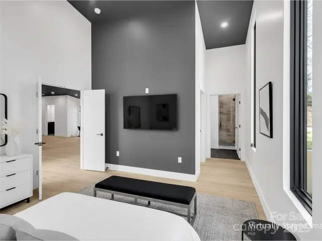 a bedroom with a bed and a large window