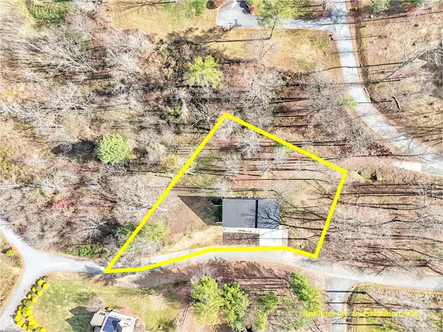 a view of a wooden house with a yard