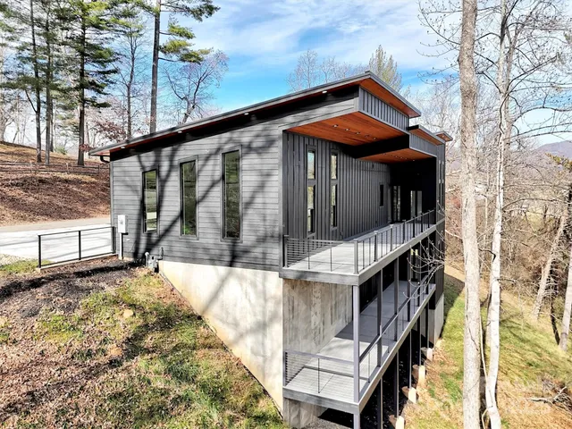 a large kitchen with a large counter top a sink stainless steel appliances and cabinets