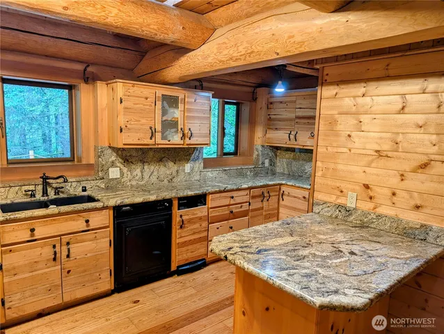 a kitchen with stainless steel appliances granite countertop wooden cabinets and a granite counter tops