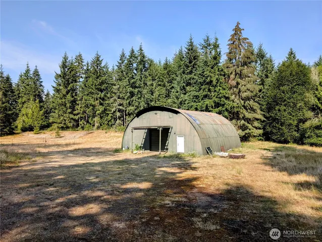 a gym room with lots of furniture and a chandelier