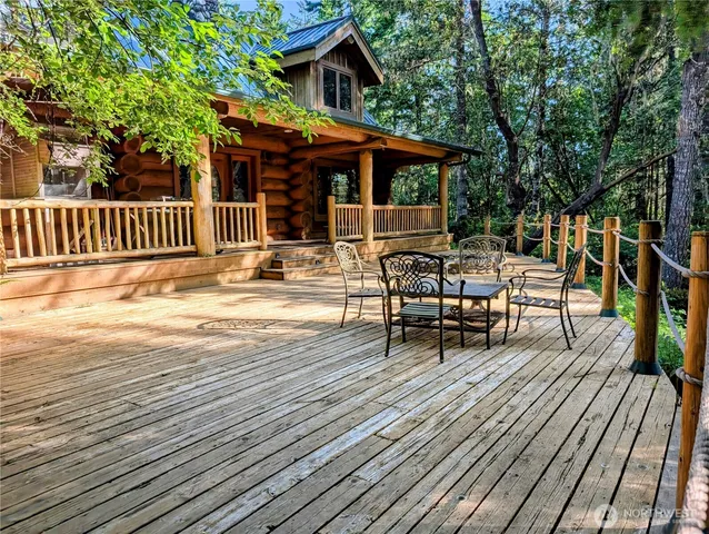 a view of a patio with table and chairs and wooden floor