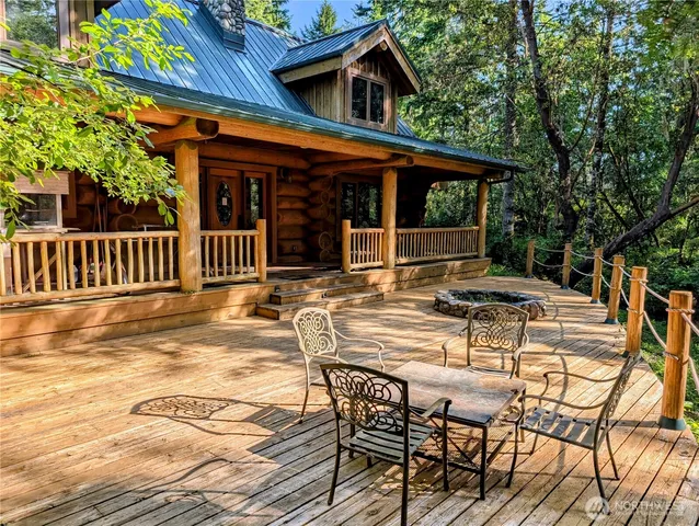 a view of a house with pool and sitting area
