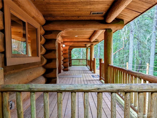 a view of porch with a floor to ceiling window and wooden floor
