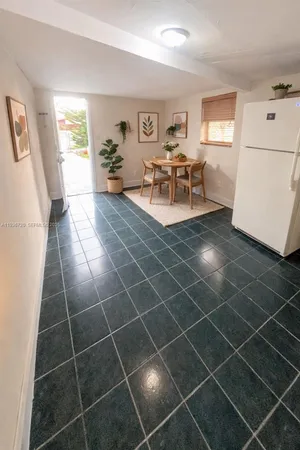 a living room with a gaming machine and a windows