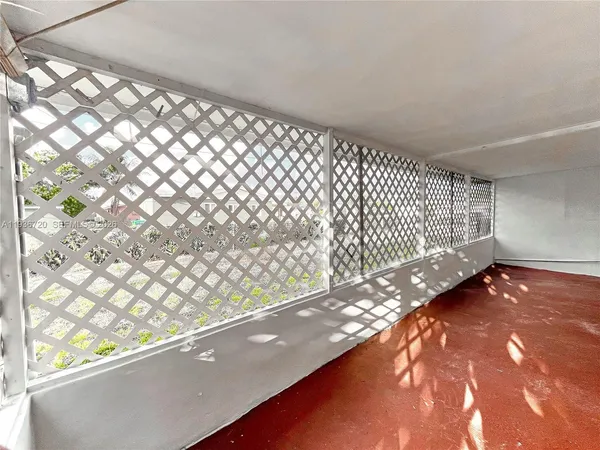 a view of a glass door with a yard from a window