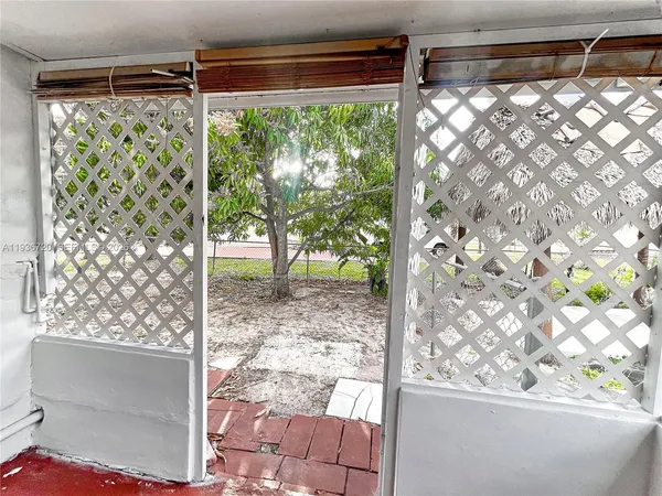 a view of a yard with plants and trees