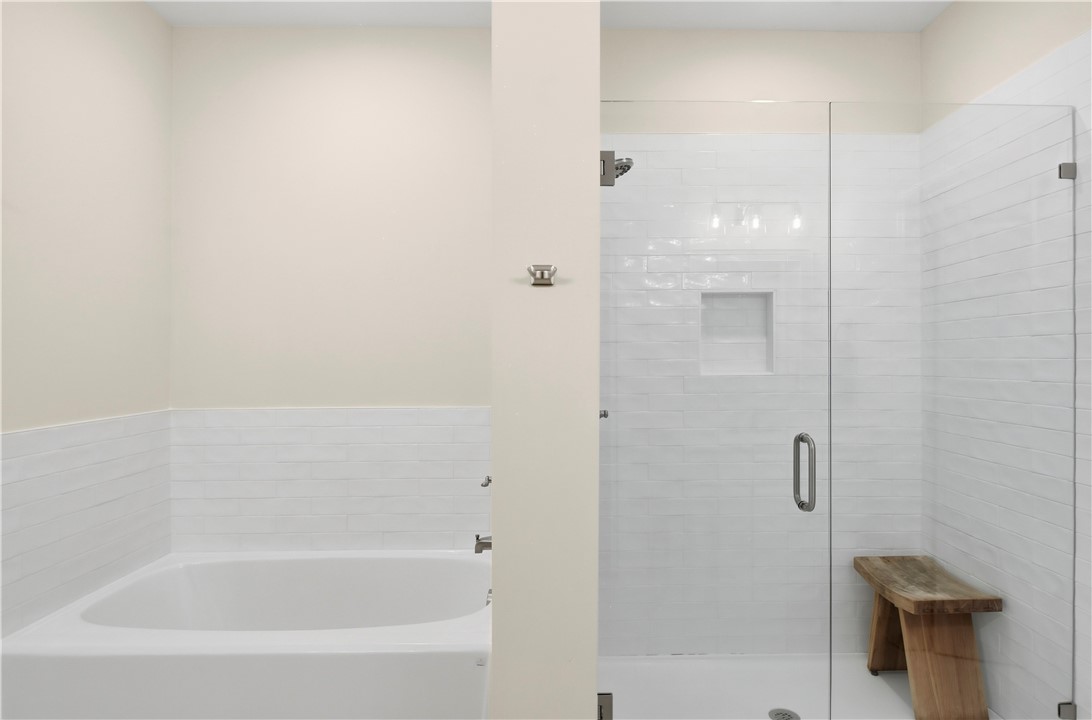 18 Edenham Court Brunswick, GA 31523 - Photo 16 of 32 Beautiful primary bath with tiled shower, bath provides luxury and comfort.