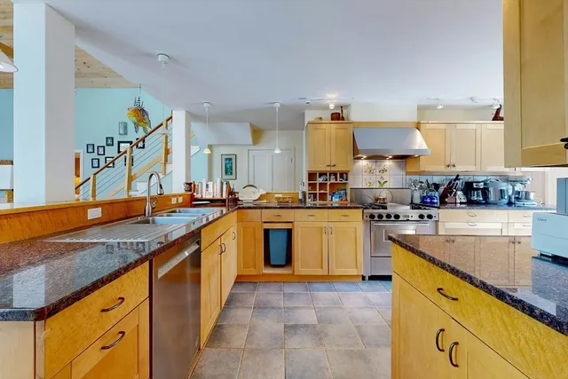 a kitchen with stainless steel appliances granite countertop a sink and cabinets