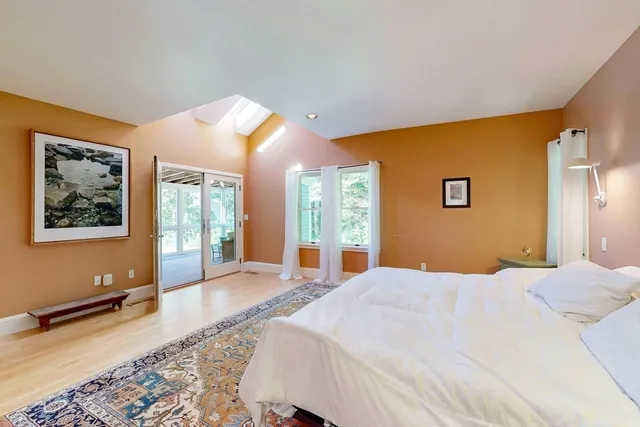 a bedroom with a bed and a lamp next to a window