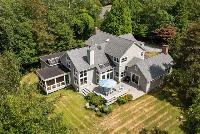 an aerial view of a backyard with swimming pool