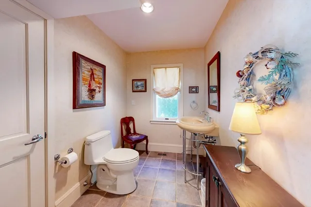 a bathroom with a toilet sink and mirror