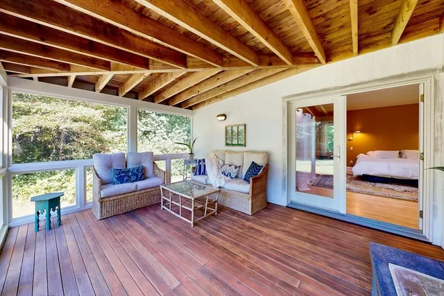 a living room with furniture and wooden floors