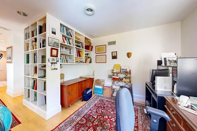 a living room with furniture cabinets and baby crib