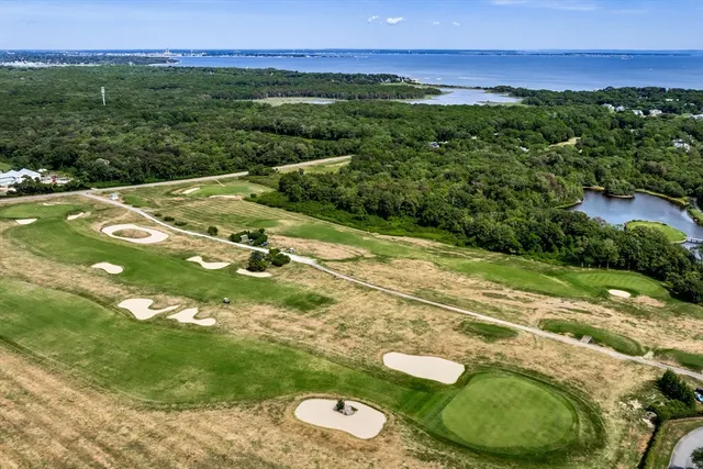 a view of a patio with lawn chairs floor to ceiling window and an ocean view