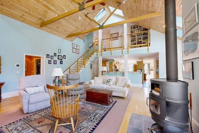 a living room with furniture a rug and a chandelier