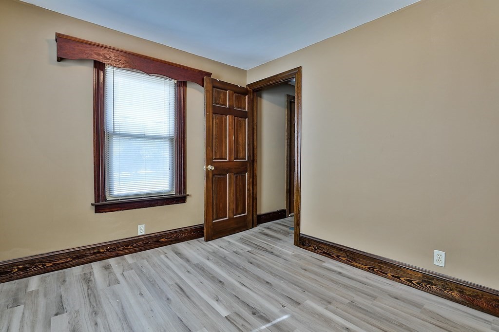 54 Meadowbrook Road Chelmsford, MA 01863 - Photo 13 of 32 a view of an empty room with wooden floor and a window