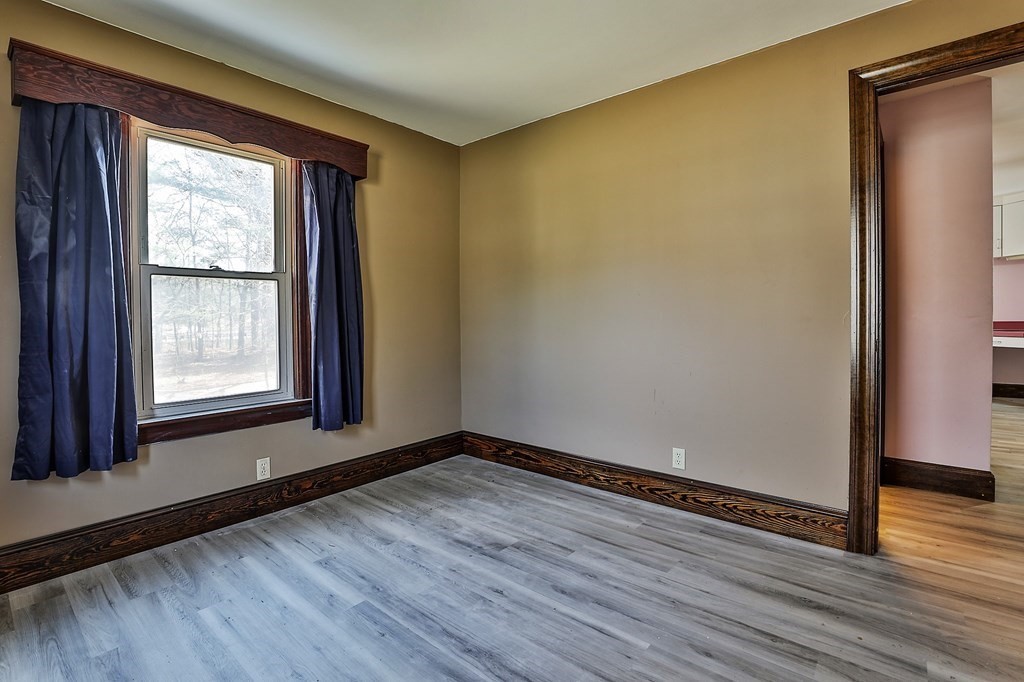 54 Meadowbrook Road Chelmsford, MA 01863 - Photo 14 of 32 a view of an empty room with wooden floor and a window