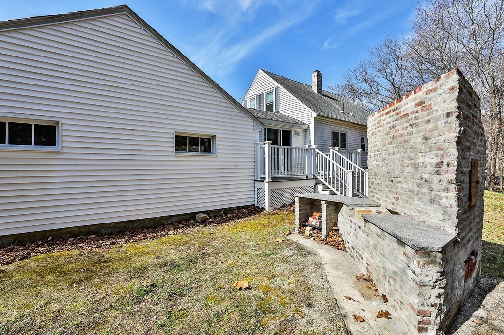54 Meadowbrook Road Chelmsford, MA 01863 - Photo 30 of 32 a front view of a house with a yard