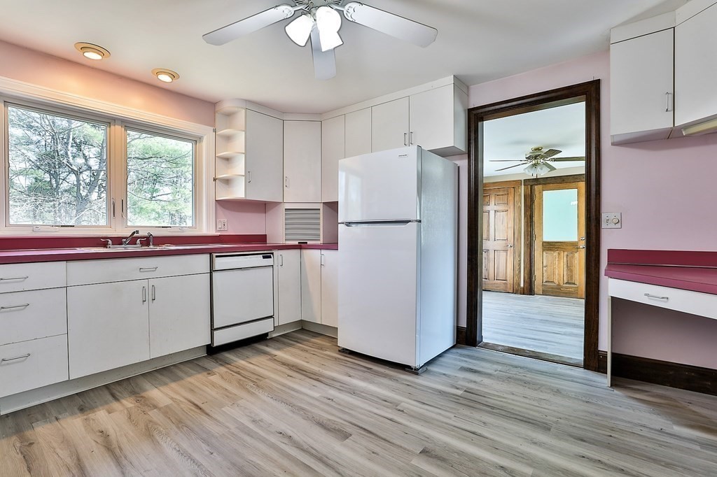 54 Meadowbrook Road Chelmsford, MA 01863 - Photo 4 of 32 a kitchen with a refrigerator a sink cabinets and wooden floor