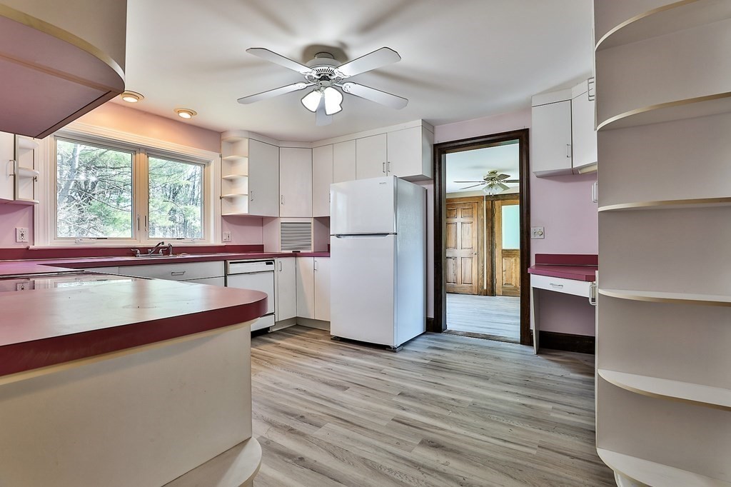 54 Meadowbrook Road Chelmsford, MA 01863 - Photo 5 of 32 a kitchen with stainless steel appliances granite countertop a refrigerator a sink and white cabinets