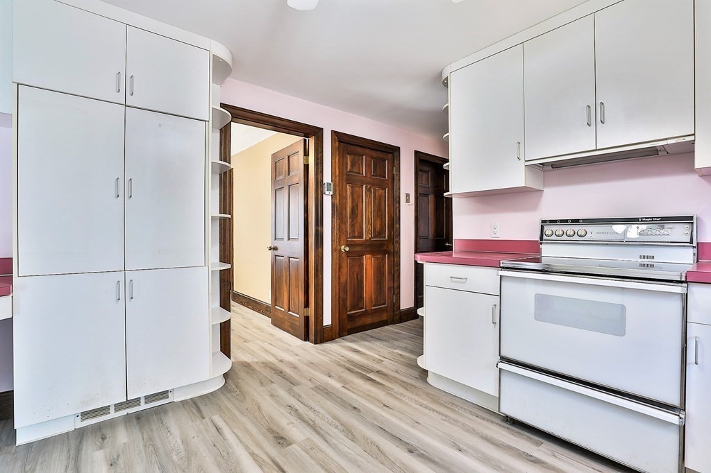 54 Meadowbrook Road Chelmsford, MA 01863 - Photo 6 of 32 a kitchen with granite countertop white cabinets and white appliances