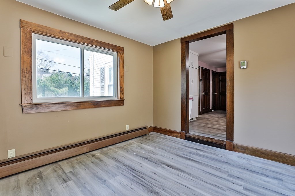 54 Meadowbrook Road Chelmsford, MA 01863 - Photo 10 of 32 an empty room with wooden floor and windows
